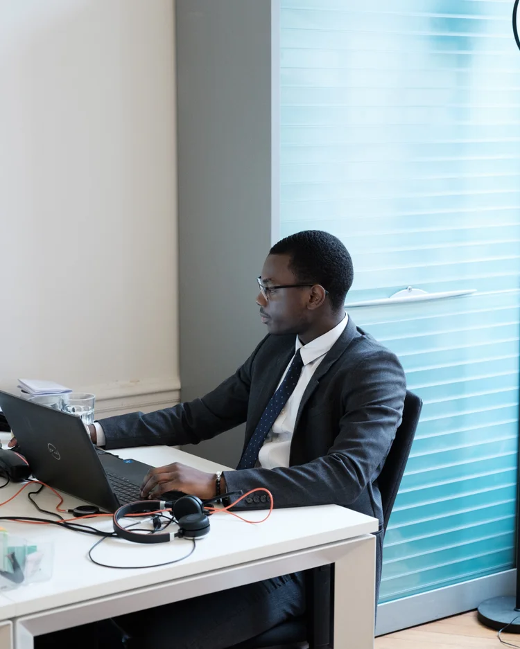 Sekou, senior bookkeeper at S&C, working at his desk